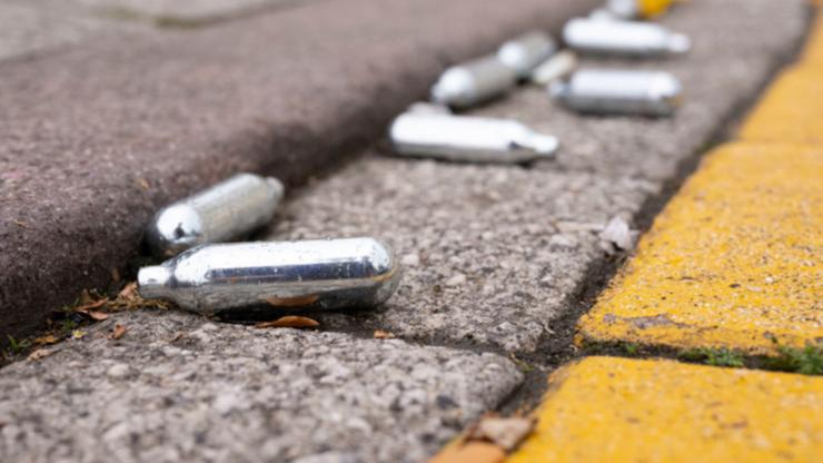 Discarded nitrous oxide bulbs, intended for making whipped cream but often inhaled for intoxication. 