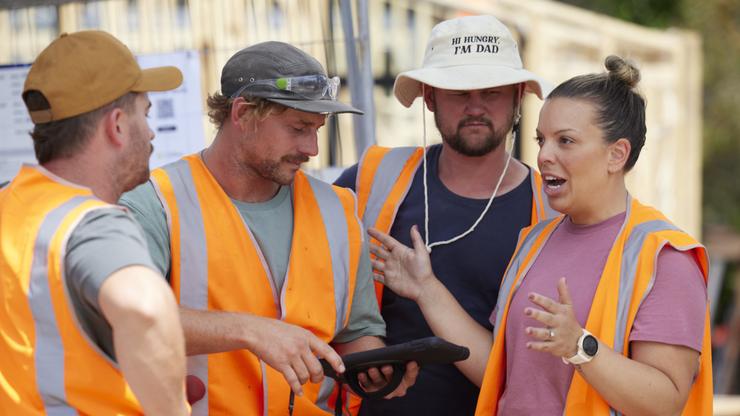 Lara and Peter discuss room measurements with Rhys and Liam. 