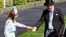 Prince William assists Carole Middleton as she gets the heel of her shoe stuck in the grass on day two of Royal Ascot 2024.